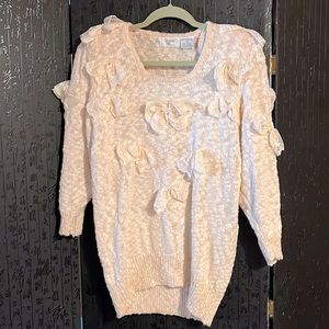 A sweet bow covered with pearl enhancements and removable shoulder pads…